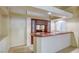 A modern wet bar features wood cabinets, sink, and countertop with attractive lattice work above in a neutral toned room at 7641 Jacaranda Bay St, Las Vegas, NV 89139