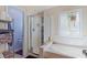 Bathroom featuring a bathtub shower combo, tiled walls, a window, and a separate toilet at 8125 Boxberry Ave, Las Vegas, NV 89131