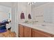 Bright bathroom featuring a double sink vanity and hardwood floors at 8125 Boxberry Ave, Las Vegas, NV 89131