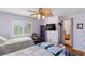 Inviting bedroom with two beds, a ceiling fan and light, and access to the bathroom at 8125 Boxberry Ave, Las Vegas, NV 89131