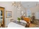 Cozy dining area featuring a chandelier, arched window, and traditional-style furnishings at 8125 Boxberry Ave, Las Vegas, NV 89131