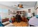 Home office featuring a desk, shelves, a ceiling fan and light, hardwood floors and ample natural light at 8125 Boxberry Ave, Las Vegas, NV 89131