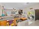 Bright kitchen featuring an island, stainless steel appliances, and sliding door to the backyard at 8125 Boxberry Ave, Las Vegas, NV 89131