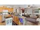 Bright kitchen featuring wood cabinets, granite countertops, and an opening to the living room at 8125 Boxberry Ave, Las Vegas, NV 89131