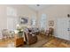 Bright living room featuring neutral tones, arched windows, and tile flooring at 8125 Boxberry Ave, Las Vegas, NV 89131