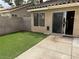 Private backyard features artificial turf, block wall and sliding glass door to the home at 8154 Flanders Terrace Dr, Las Vegas, NV 89123