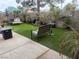 Landscaped backyard features patio with seating, artificial turf, and water feature at 8154 Flanders Terrace Dr, Las Vegas, NV 89123