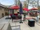 Large patio area with outdoor seating, umbrellas, and beautiful landscaping at 8154 Flanders Terrace Dr, Las Vegas, NV 89123