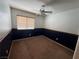 Bedroom with a paneled accent wall, ceiling fan, and carpet at 8154 Flanders Terrace Dr, Las Vegas, NV 89123