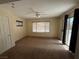 Cozy bedroom featuring plush carpet, bright windows, ceiling fan, and door to backyard at 8154 Flanders Terrace Dr, Las Vegas, NV 89123