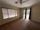 Bedroom with a ceiling fan, bright windows, and direct access to the backyard at 8154 Flanders Terrace Dr, Las Vegas, NV 89123