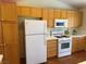 Bright kitchen with light wood cabinets, white appliances, and tile floors at 8154 Flanders Terrace Dr, Las Vegas, NV 89123