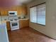 Kitchen with tile floors, wood cabinets, and white appliances at 8154 Flanders Terrace Dr, Las Vegas, NV 89123