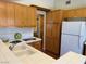 Clean kitchen featuring light wood cabinets, white tile countertops, and double sink at 8154 Flanders Terrace Dr, Las Vegas, NV 89123