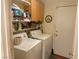 Dedicated laundry room with washer, dryer, storage shelves, and utility sink at 8154 Flanders Terrace Dr, Las Vegas, NV 89123