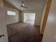 Inviting living room with plush carpeting, a ceiling fan, and view into another room at 8154 Flanders Terrace Dr, Las Vegas, NV 89123