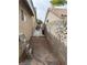 A side yard with a decorative sun on the wall and a gate leading to the backyard at 8154 Flanders Terrace Dr, Las Vegas, NV 89123