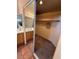 Walk-in closet next to a full bathroom featuring mirrored doors, carpet, and shelves at 8154 Flanders Terrace Dr, Las Vegas, NV 89123