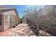 Side yard featuring a walkway lined with plants and a fenced yard at 8216 Gillette St, Las Vegas, NV 89117