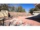 Backyard featuring a storage shed, red tiled patio and block wall at 8216 Gillette St, Las Vegas, NV 89117
