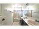 Bathroom featuring a dual sink vanity and shower with sliding glass door at 8216 Gillette St, Las Vegas, NV 89117