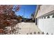 The three car garage with a long driveway and wrought iron fence and gate at 8216 Gillette St, Las Vegas, NV 89117