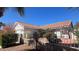 Exterior view of the single-story home with tile roof and landscaped front yard at 8216 Gillette St, Las Vegas, NV 89117