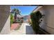 View from the covered front porch out to a red brick walkway and palm tree at 8216 Gillette St, Las Vegas, NV 89117