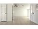A spacious living room with tile flooring, ceiling fan, and light neutral walls at 8216 Gillette St, Las Vegas, NV 89117