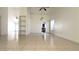 Spacious living area with tile flooring, a ceiling fan, and easy kitchen access at 8216 Gillette St, Las Vegas, NV 89117