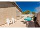 This backyard features a pool, desert landscaping, and outdoor seating at 8266 Lincoln Valley St, Las Vegas, NV 89123