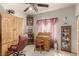 This bedroom features an armoire, a corner curio cabinet and a small roll-top desk at 8266 Lincoln Valley St, Las Vegas, NV 89123
