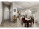 Dining area showcases a chandelier, large windows, and easy access to kitchen, perfect for modern living at 8266 Lincoln Valley St, Las Vegas, NV 89123