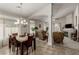 Open-concept living and dining area featuring tile floors, neutral walls, and comfortable seating, with a fireplace focal point at 8266 Lincoln Valley St, Las Vegas, NV 89123