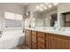 Main bathroom with double sink vanity, soaking tub, and separate shower, designed for relaxation and convenience at 8266 Lincoln Valley St, Las Vegas, NV 89123