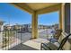 Relaxing covered balcony overlooking the street with comfortable seating for outdoor enjoyment at 8490 Classique Ave # 101, Las Vegas, NV 89178