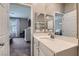 Modern bathroom featuring a large mirror and vanity, with a view to the bedroom at 8490 Classique Ave # 101, Las Vegas, NV 89178