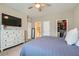 Spacious bedroom featuring an organized walk-in closet, ensuite bathroom, and white dresser at 8490 Classique Ave # 101, Las Vegas, NV 89178