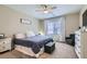 Comfortable bedroom with a ceiling fan, a cozy chair, and ample natural light at 8490 Classique Ave # 101, Las Vegas, NV 89178