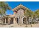 Beautiful stone-clad clubhouse with arched entryways, windows and well-maintained landscaping at 8490 Classique Ave # 101, Las Vegas, NV 89178