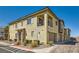 Two-story exterior showcasing a private balcony, attached garages, and desert landscaping at 8490 Classique Ave # 101, Las Vegas, NV 89178