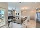 Open-concept kitchen featuring stainless appliances, a granite island, and access to the living area at 8490 Classique Ave # 101, Las Vegas, NV 89178