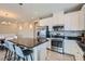Open kitchen with a granite island, stainless steel appliances, and white cabinetry at 8490 Classique Ave # 101, Las Vegas, NV 89178