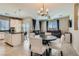 Open living space with a large dining table, ceiling fan, and comfortable couches at 8490 Classique Ave # 101, Las Vegas, NV 89178