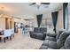Open-concept living room features neutral tones, a ceiling fan, and lots of natural light at 8490 Classique Ave # 101, Las Vegas, NV 89178