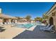 Sparkling community pool with lounge chairs, shaded seating areas, and well-maintained landscaping at 8490 Classique Ave # 101, Las Vegas, NV 89178