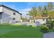Expansive backyard featuring a putting green, lush landscaping, and a detached garage at 8717 Kingship Ct, Las Vegas, NV 89129