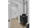 Modern powder room with black vanity and black framed mirror at 8717 Kingship Ct, Las Vegas, NV 89129