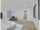 Bedroom with wood flooring, large windows, and stylish decor offers a peaceful retreat at 8717 Kingship Ct, Las Vegas, NV 89129