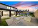 Backyard with outdoor seating and pristine lawn, perfect for relaxation and entertaining at 8717 Kingship Ct, Las Vegas, NV 89129